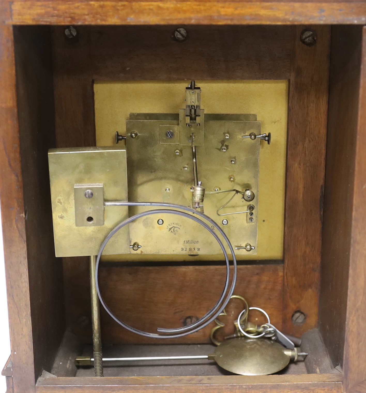 A 19th century walnut and mahogany mantel clock with Black Forest Lenzkirch AUG ‘1 Million’ movement, striking on a coiled gong, 34cm high